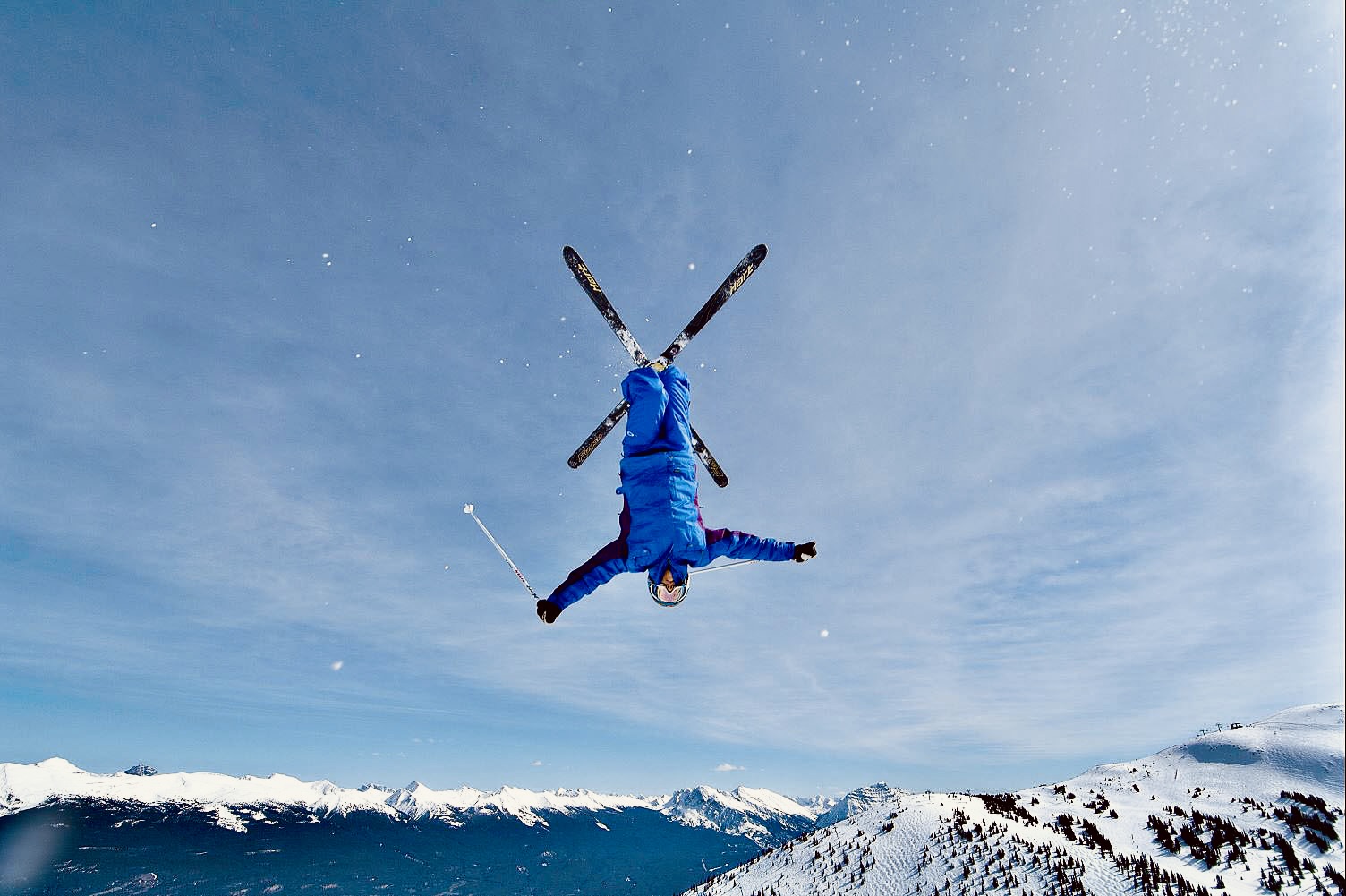 Jenn Heil skiing above a mountain range