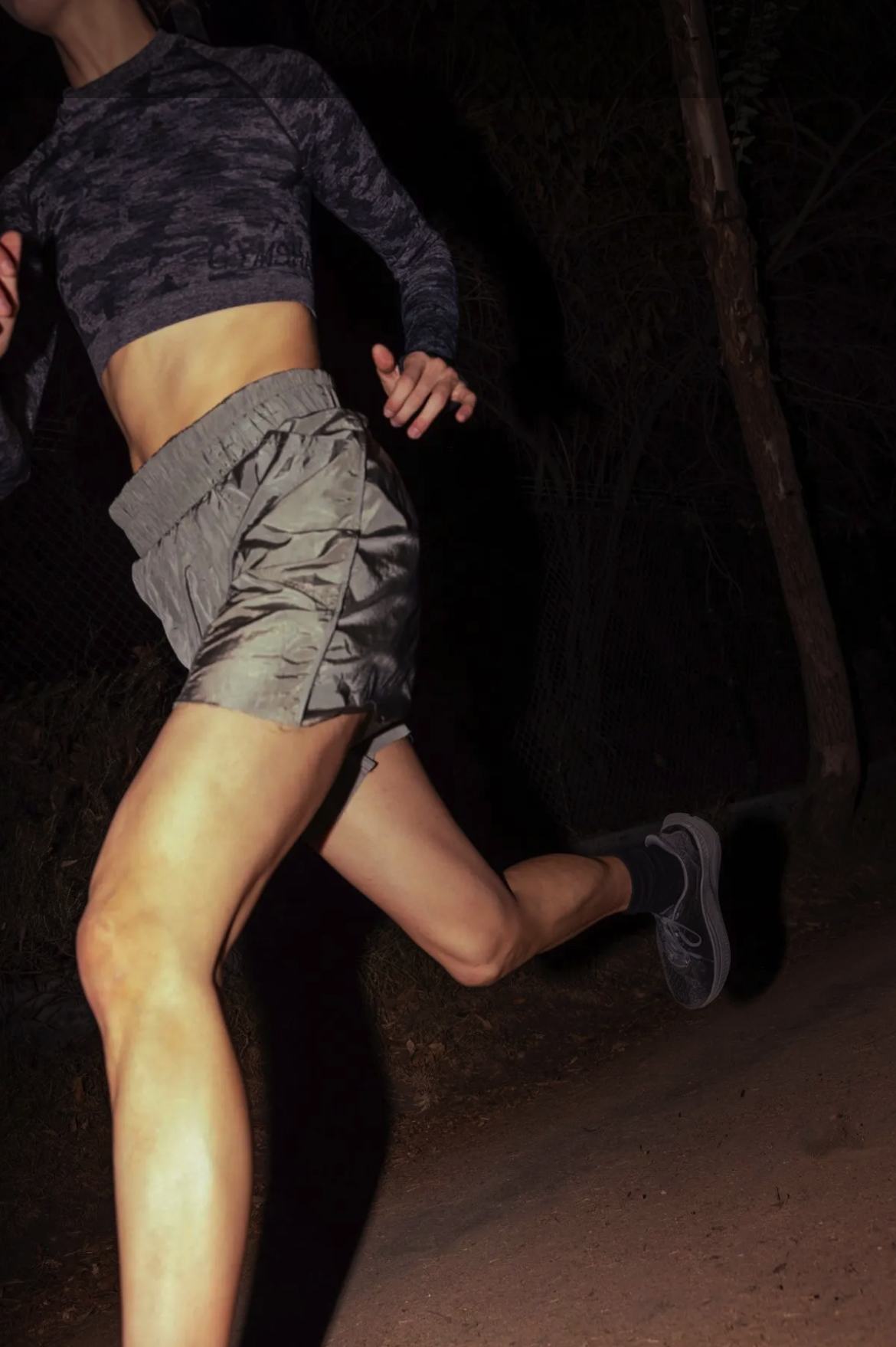 Woman running outdoors at night